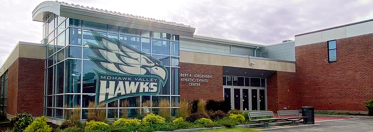 Brick building with Hawk athletics logo on glass window, Robert R. Jorgensen Athletic/Event Center